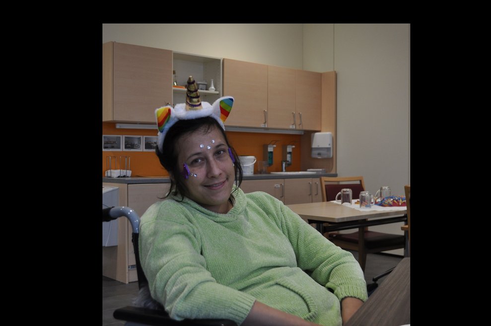 eine Frau mit Einhorn Haarreifen am Kopf bei der Faschingsfeier