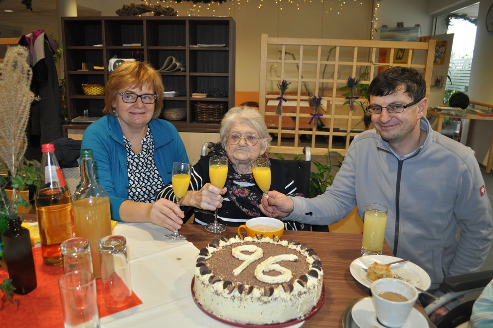 3 Personen stoßen zum 96.ten Geburtstag an.