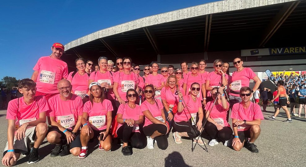 Mehrere Personen in pinken Sport T-Shirts vor der NV Arena